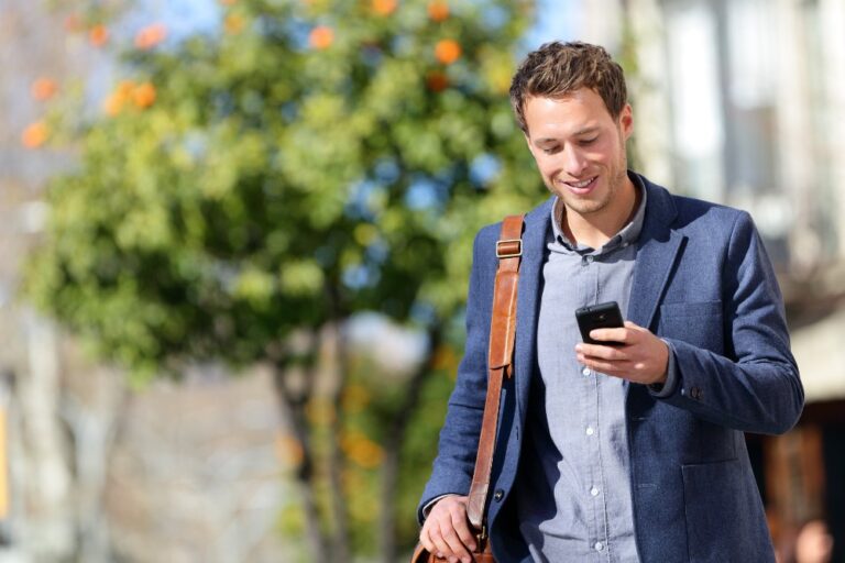 homem feliz usando celular e conferindo o consignado clt